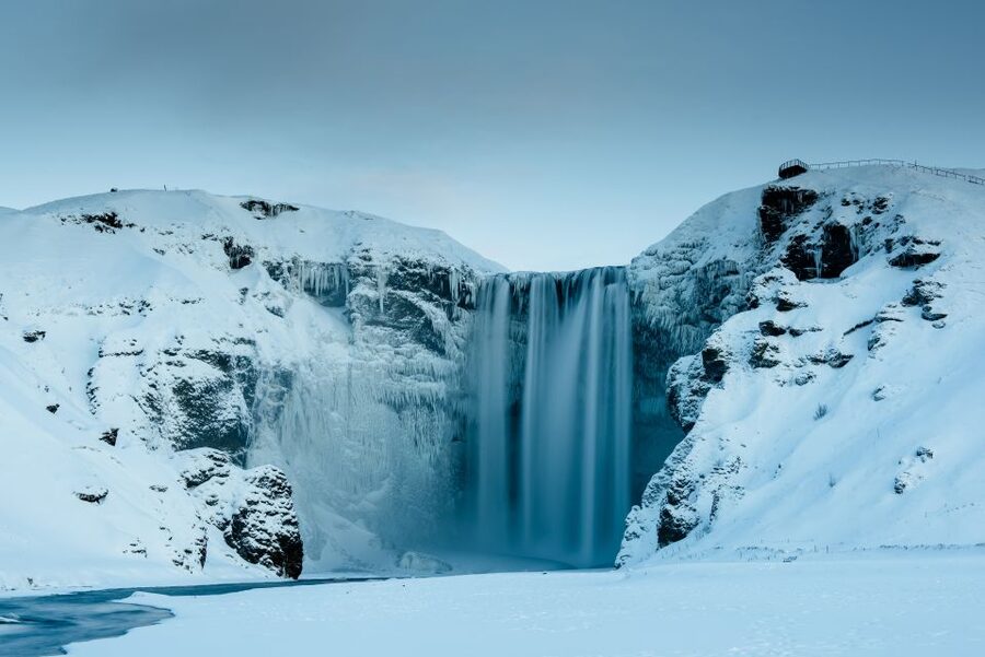 From Reykjavik 2-Day South Coast Tour with Blue Ice Cave - Entering a seasonal blue ice cave in Vatnajökull National Park