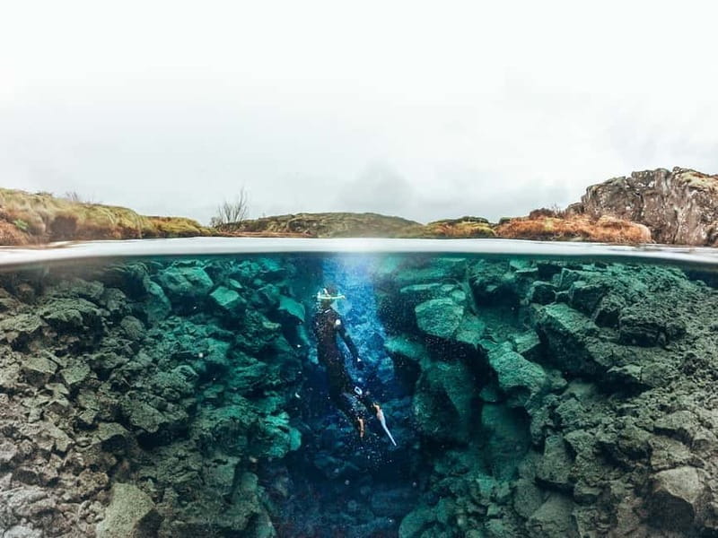 From Reykjavik: Silfra Snorkeling with Free Photos - Entering the fissure with your guide