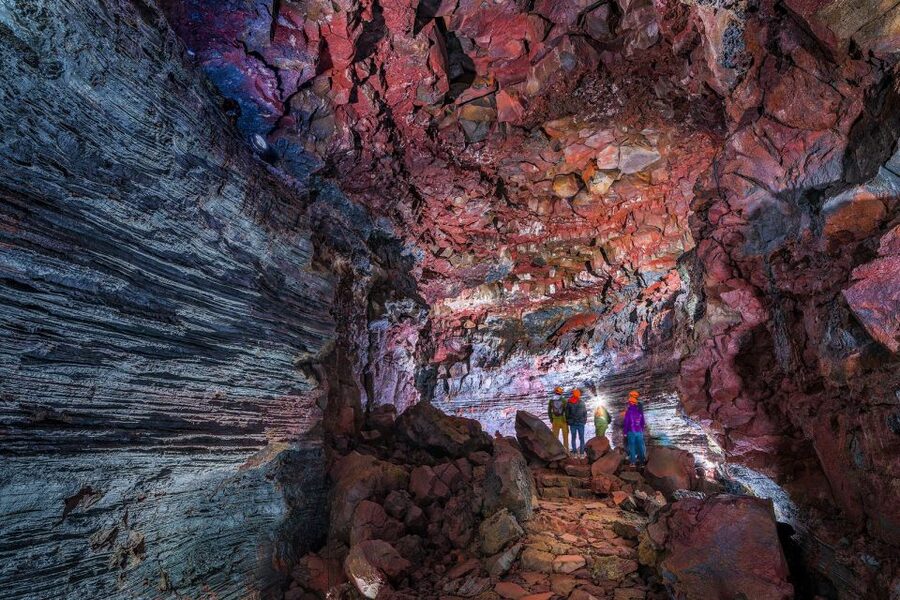 Raufarhólshellir: Lava Falls Adventure Tour - Entering the tunnel with a helmet and headlamp